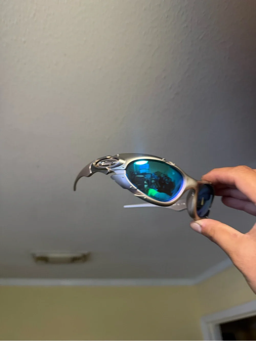 Oakley Silver Frame Sunglasses with Blue-Green Mirrored Lenses